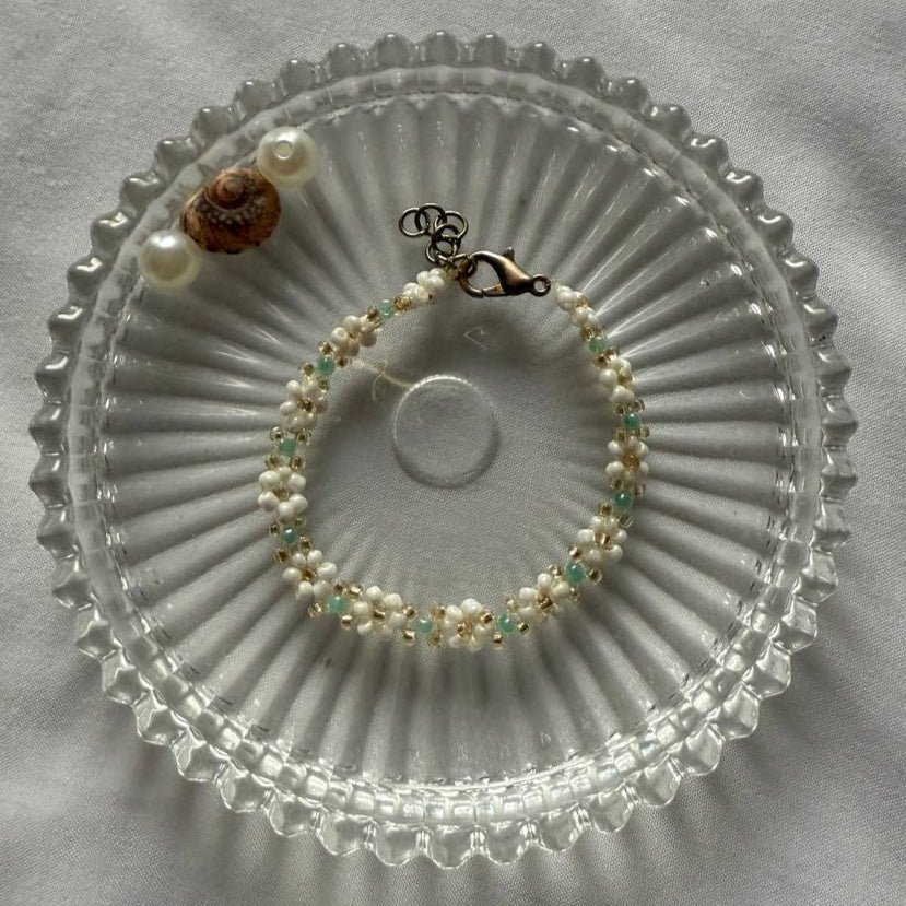 Perlenarmband mit weißen Blumen und kleinen türkisen perlen
